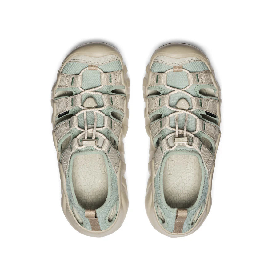 Pair of beige and light blue sandals on a white background