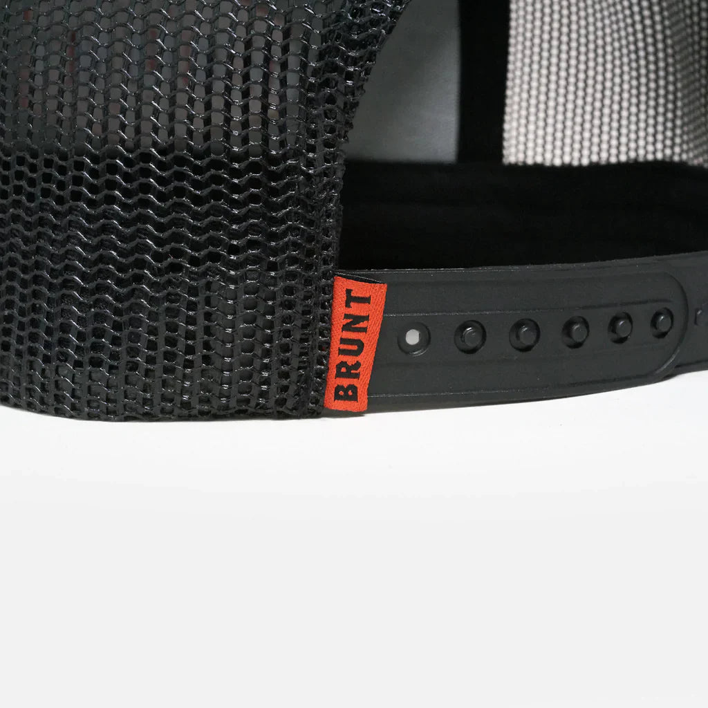Close-up of a black mesh cap with a red 'BRUNT' logo on the strap.
