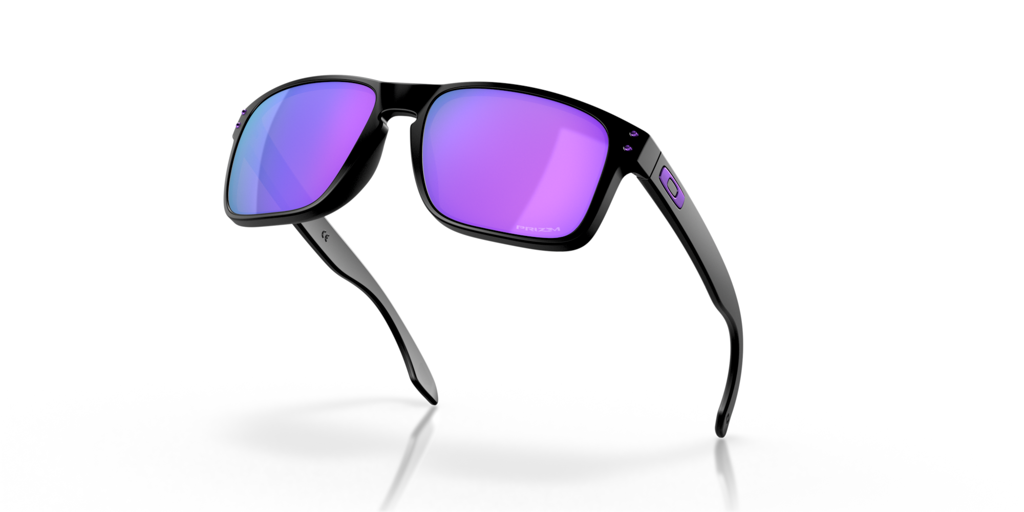 Sunglasses with purple lenses and black frame on a reflective black surface