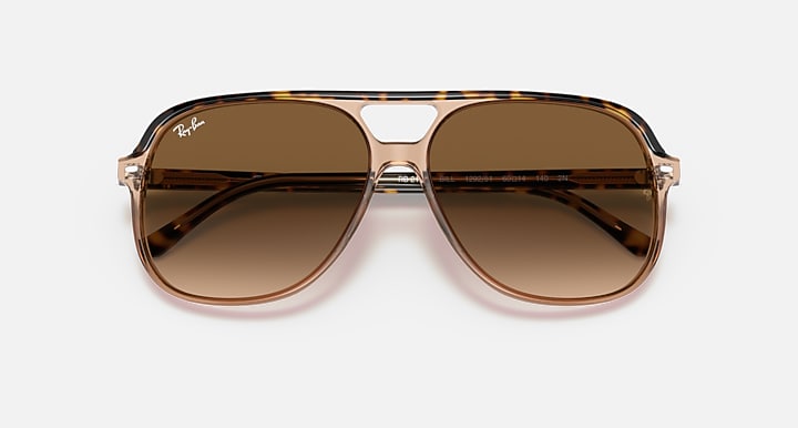 Aviator sunglasses with brown gradient lenses on a white background