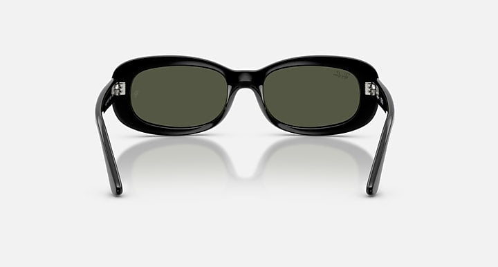 Black sunglasses with green lenses on a white background