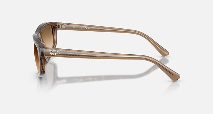 Brown sunglasses with a clear frame on a white background