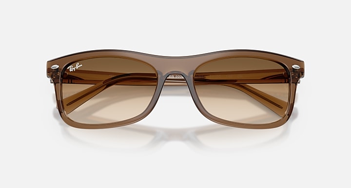 Brown sunglasses with a clear frame on a white background