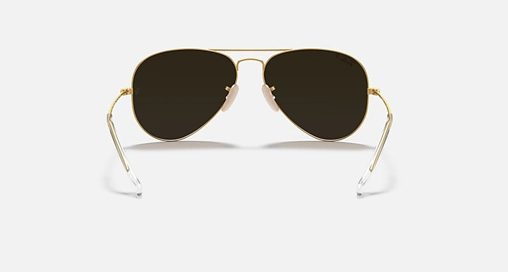 Aviator sunglasses with gold frame and dark lenses on a white background