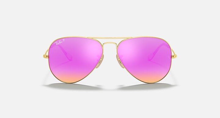 Aviator sunglasses with pink gradient lenses and gold frame on a white background