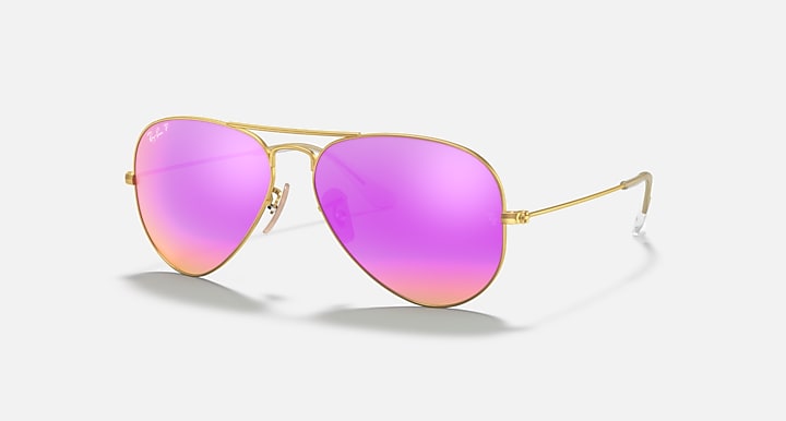 Aviator sunglasses with pink gradient lenses and gold frame on a white background