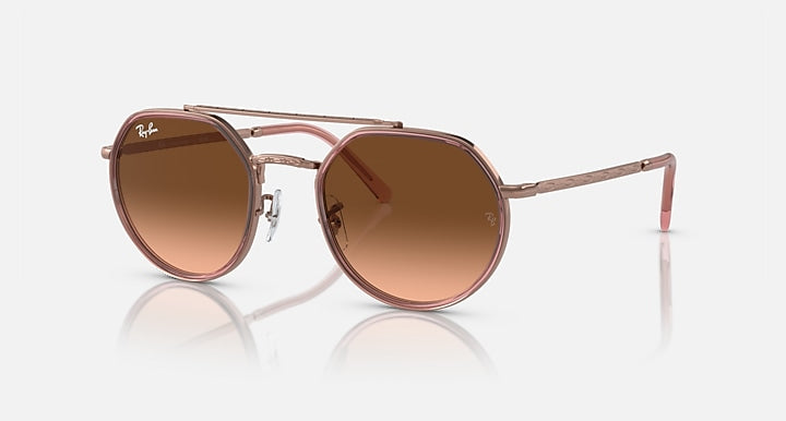 Round sunglasses with brown gradient lenses on a white background