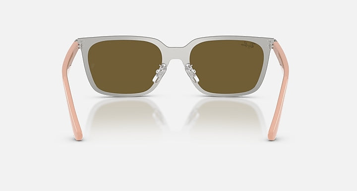 Sunglasses with pink frames and reflective lenses on a white background