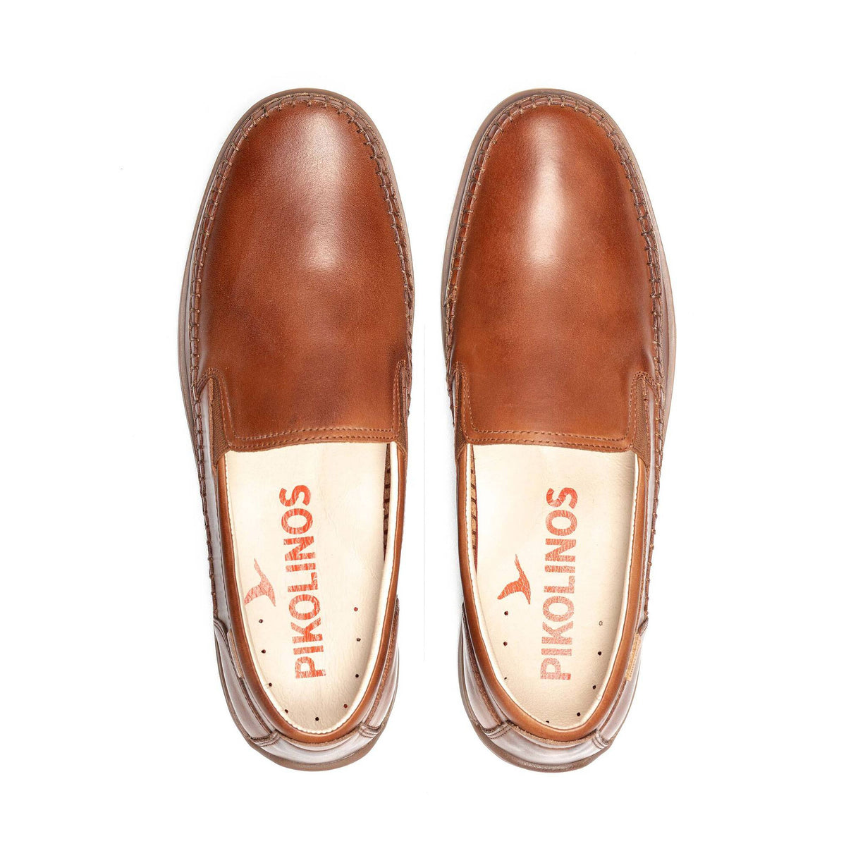 Pair of brown leather shoes with 'Pikolinos' branding on a white background
