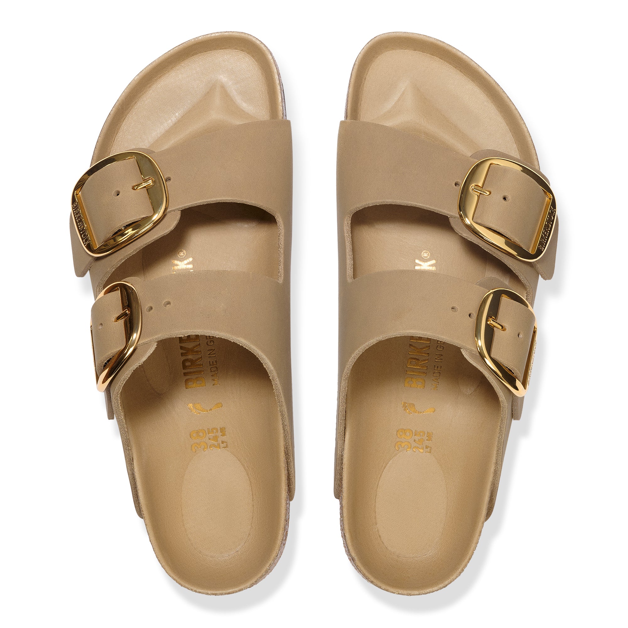Beige sandals with gold buckles on a white background