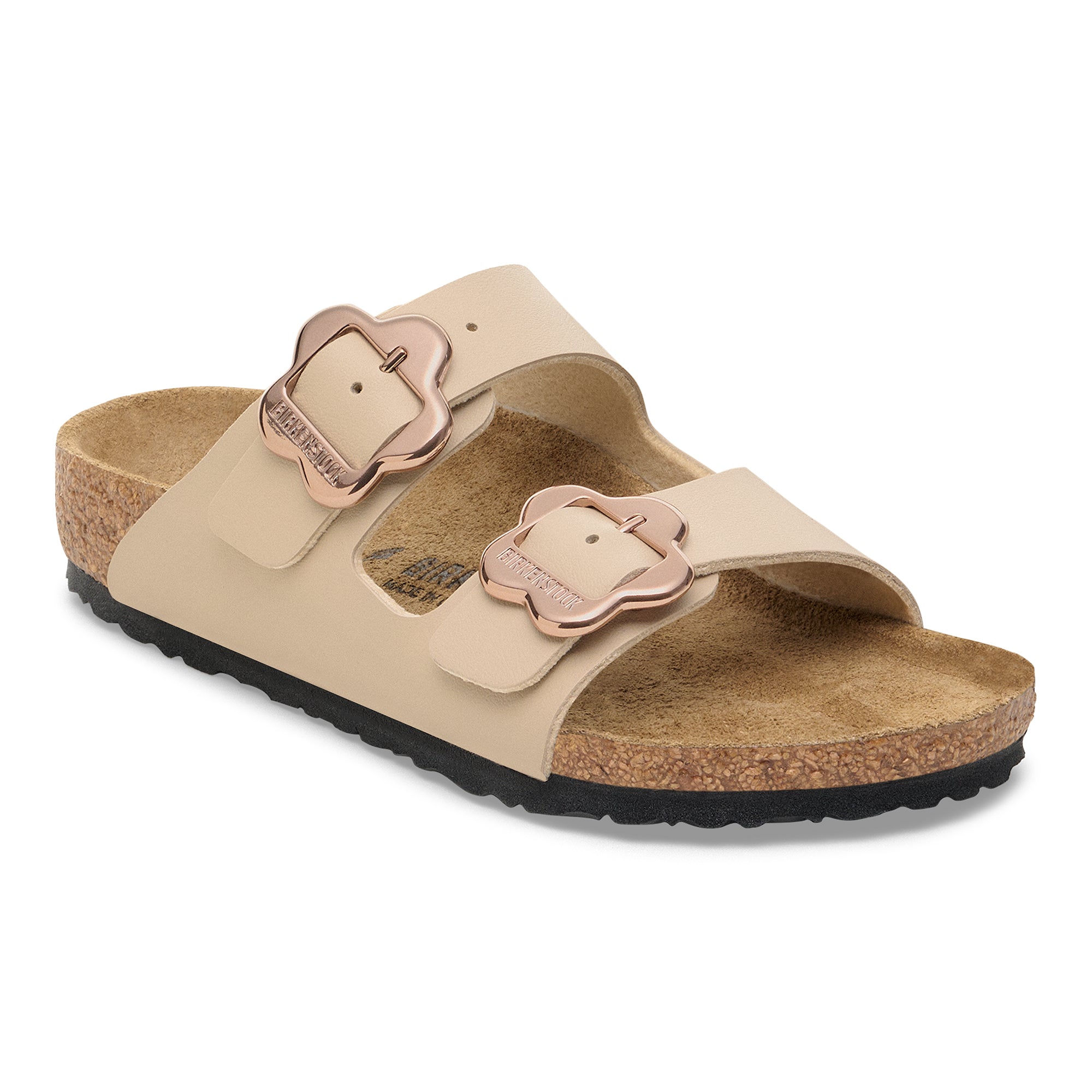 Beige sandal with rose gold buckles on a white background