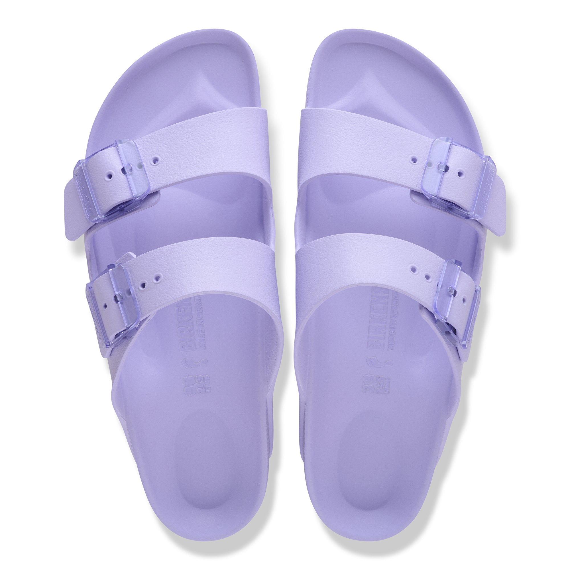 Pair of purple sandals with buckles on a white background