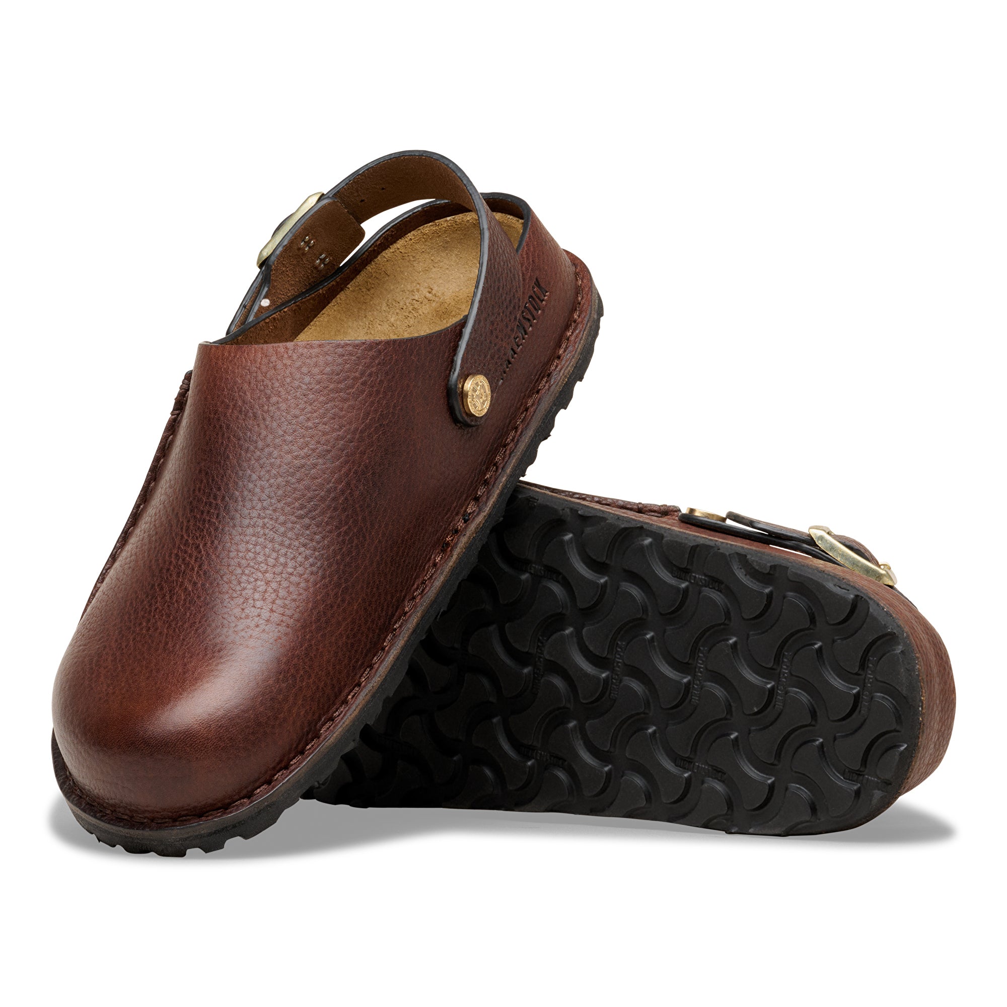 Brown leather clogs with black soles on a white background