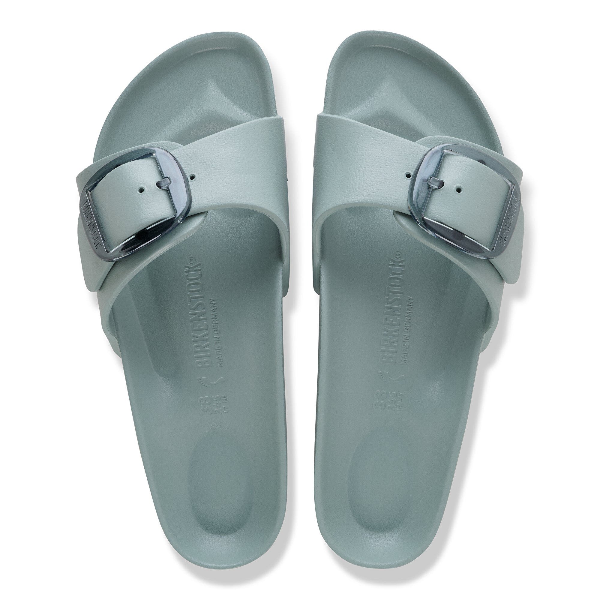 Pair of light blue sandals with a buckle on a white background
