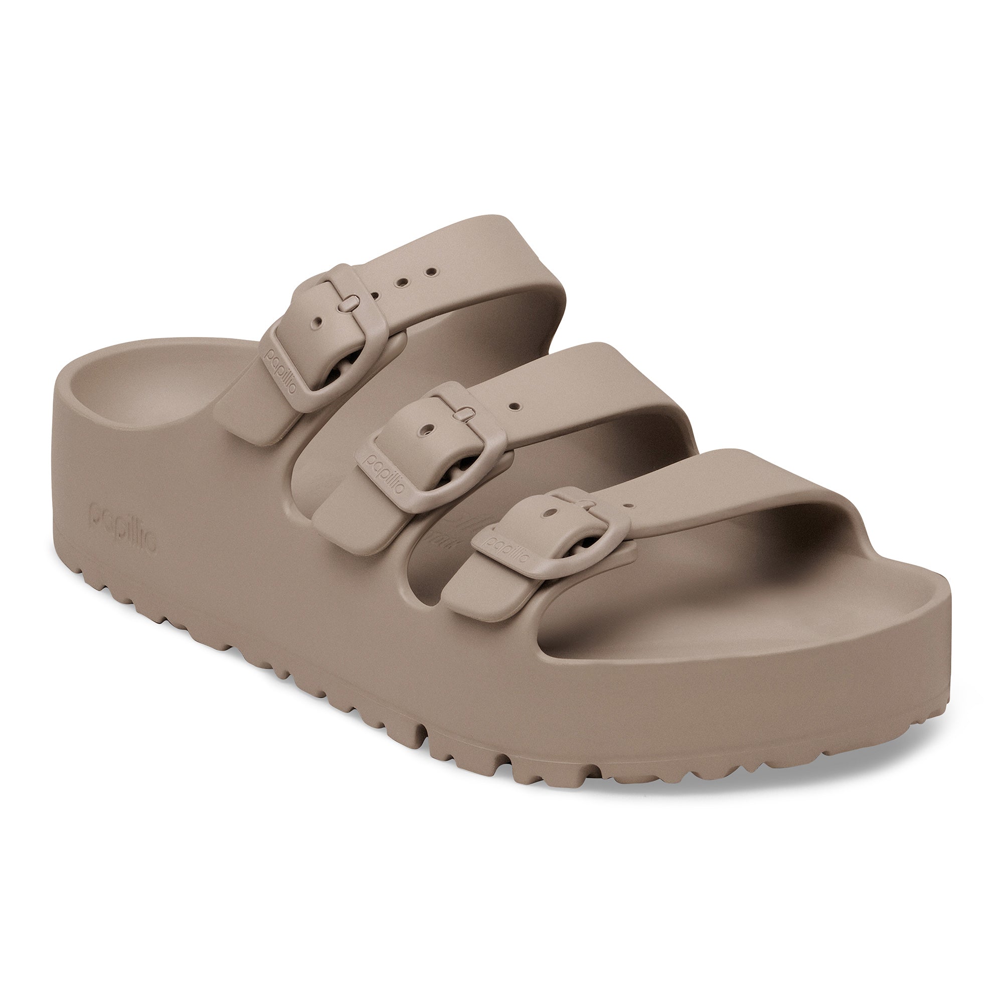 Beige sandal with double buckle strap on a white background