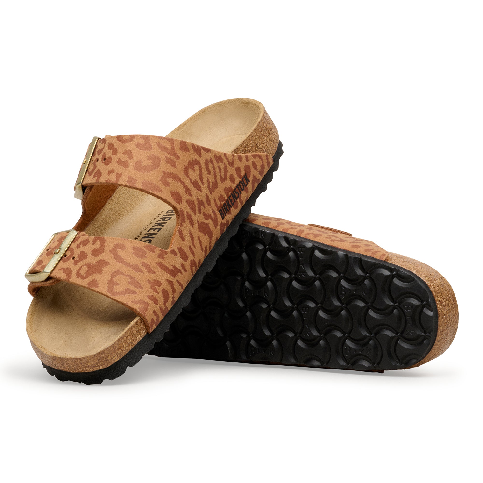 Pair of leopard print sandals with cork sole on a white background