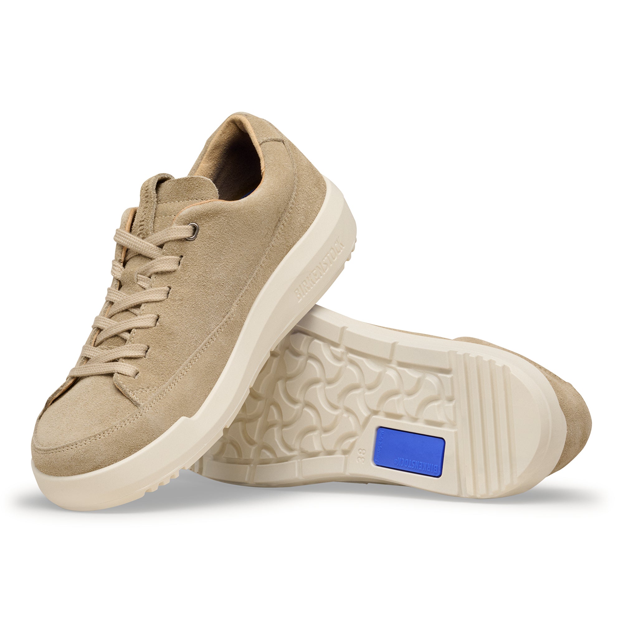 Beige sneakers with a blue label on a white background