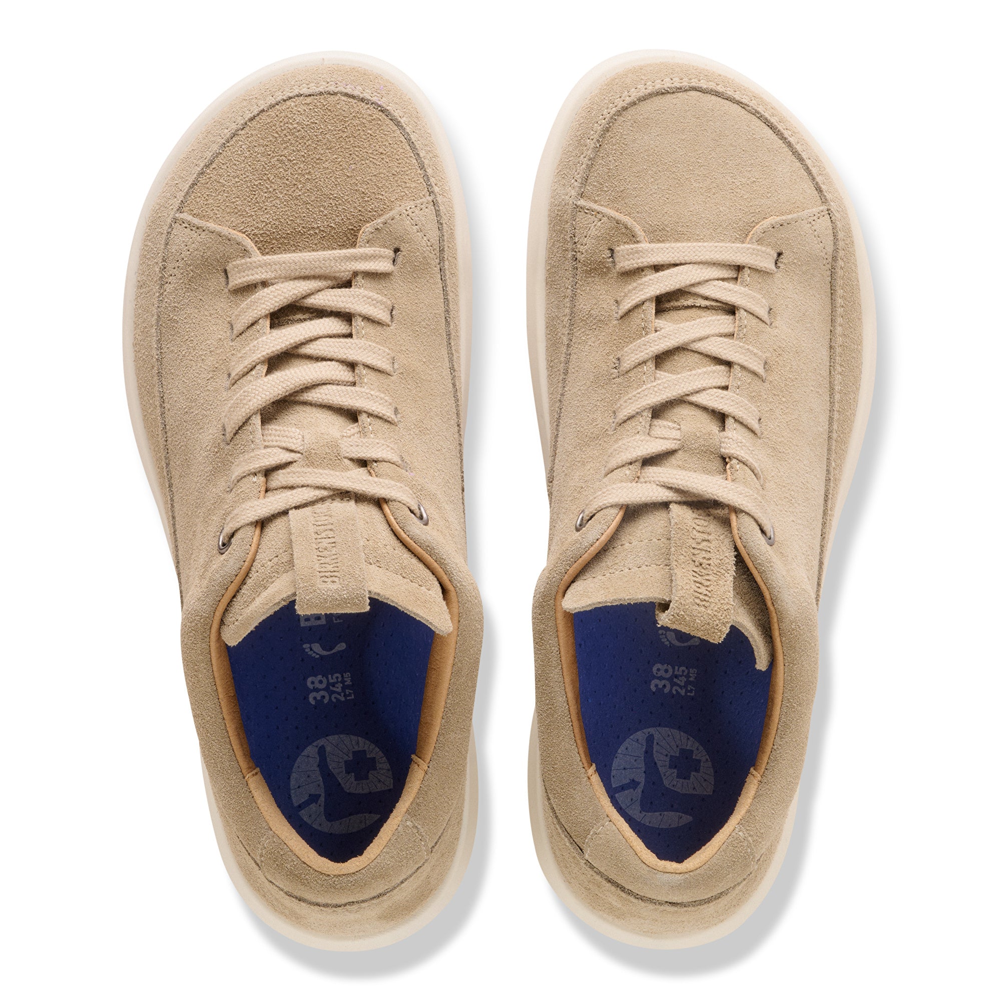 Pair of beige sneakers with blue lining on a white background