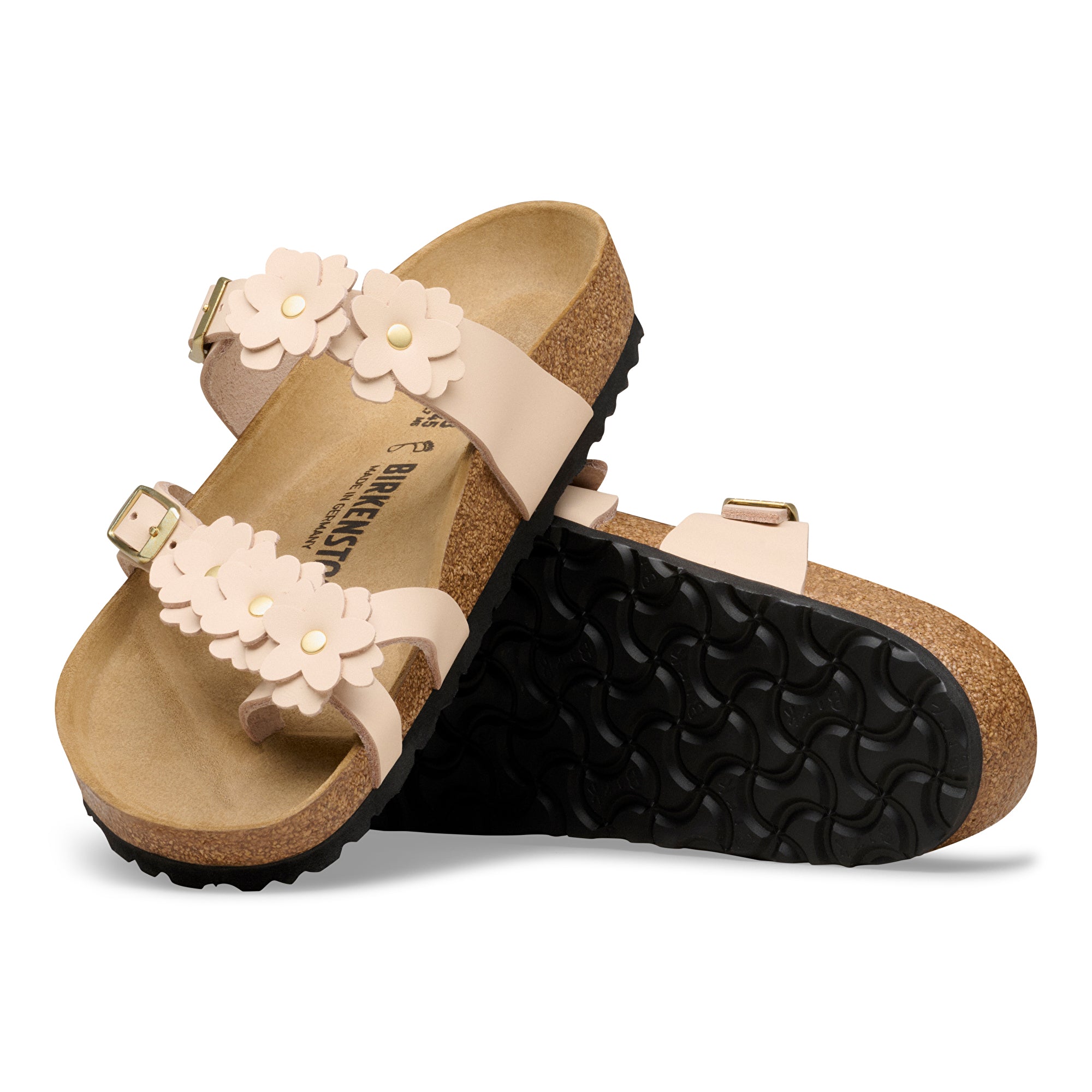 Pair of sandals with floral decorations on a white background