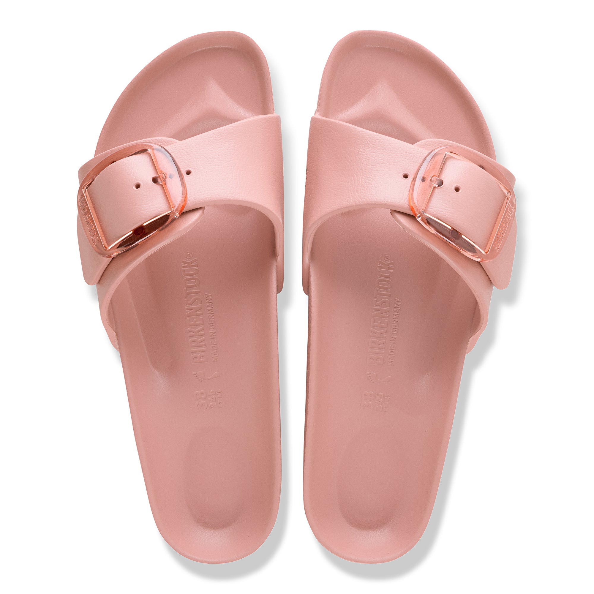 Pair of pink slides with a buckle on a white background