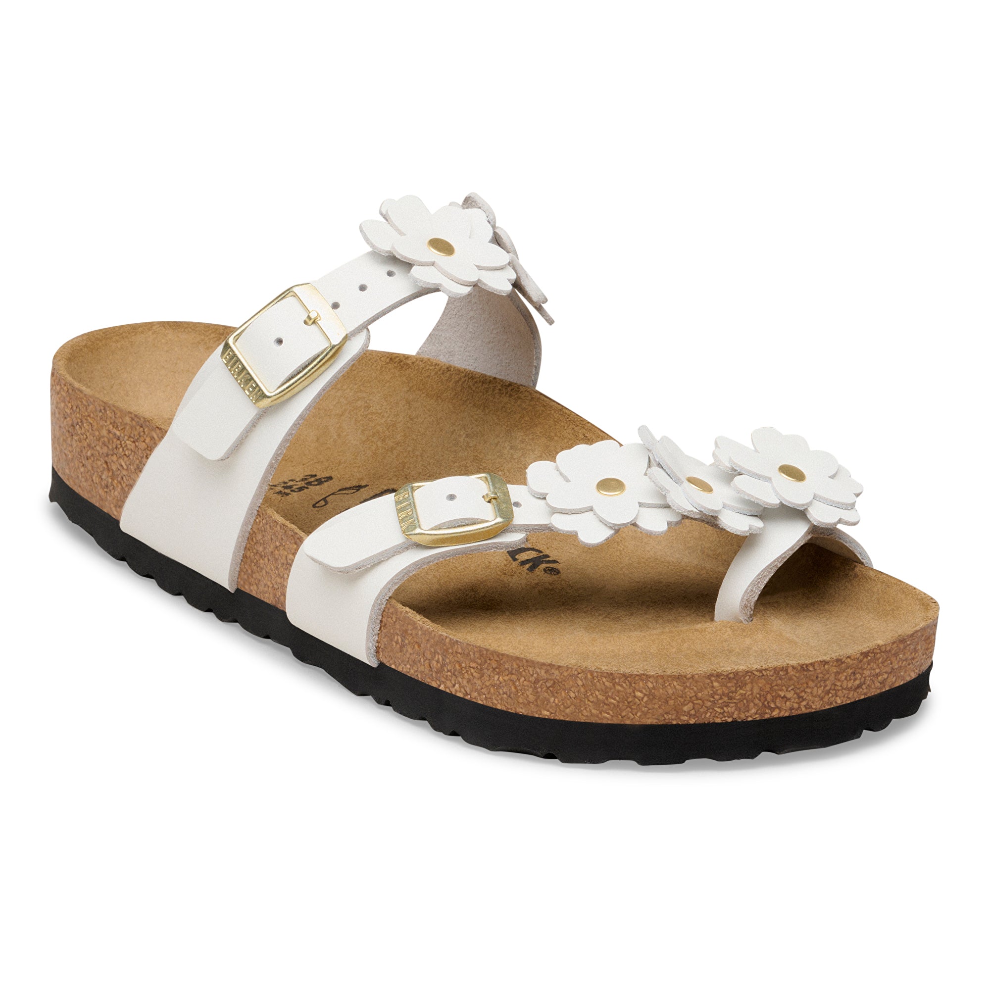 White sandal with floral designs on a cork sole against a white background
