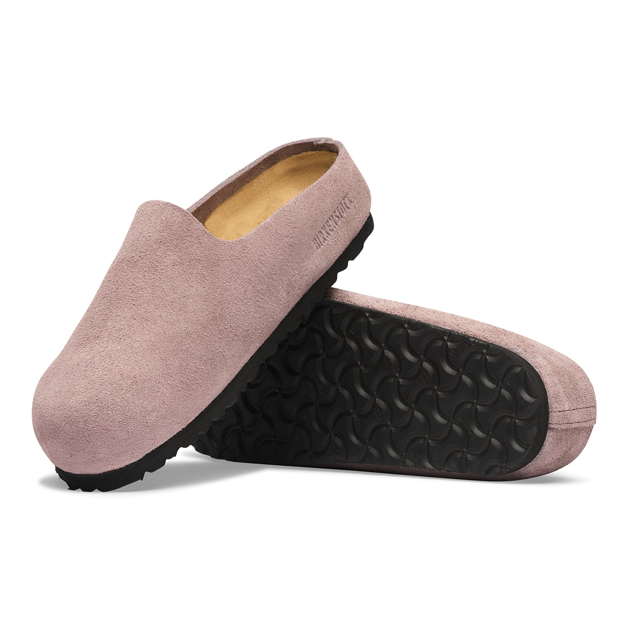 Pair of pink slippers with black sole on a white background