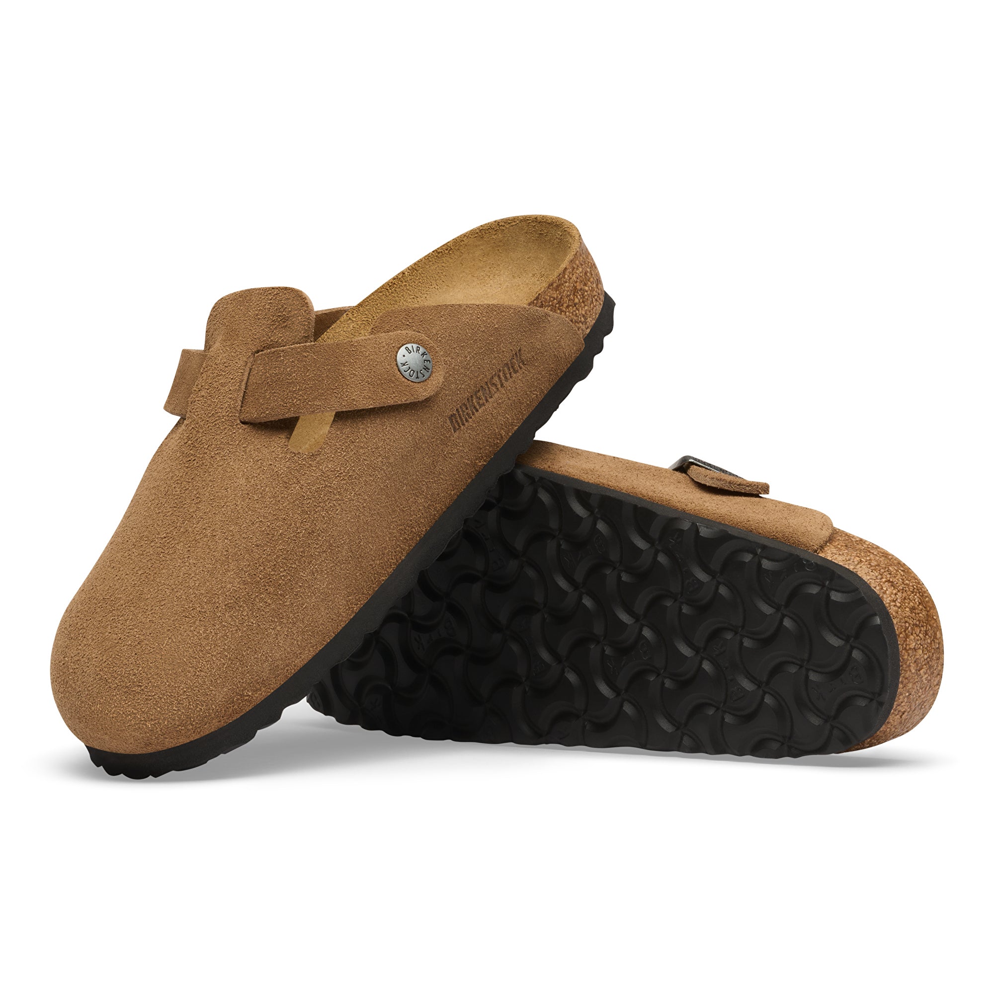Pair of brown suede clogs with black soles on a white background