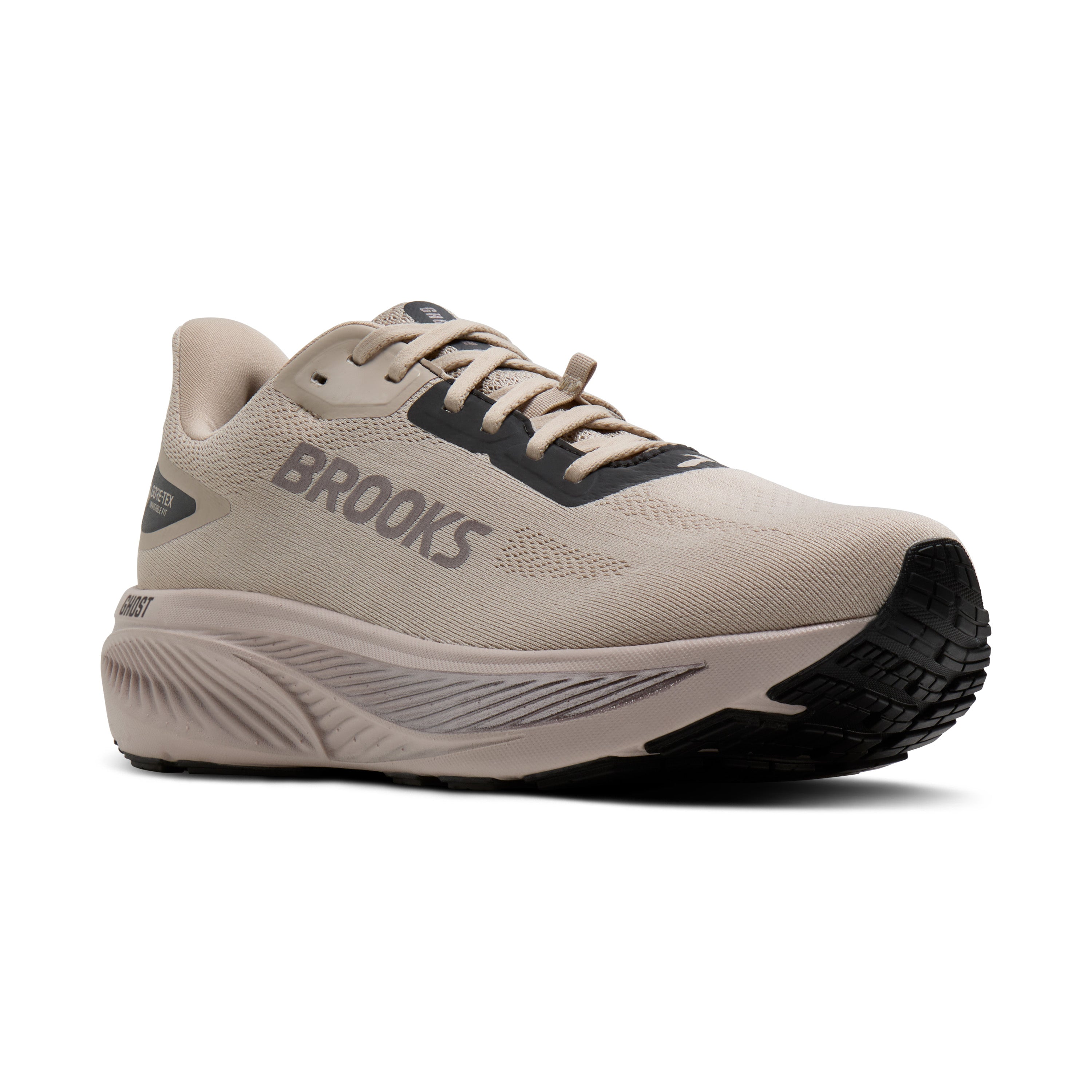 Brooks running shoe in beige and black, shown from a side profile view on a white background.