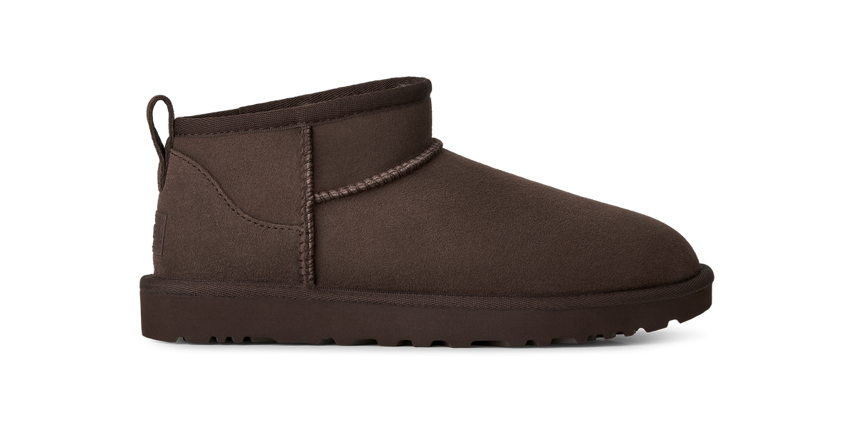 A single dark brown suede ankle boot with a thick sole and a small heel pull tab, shown in profile against a plain white background.