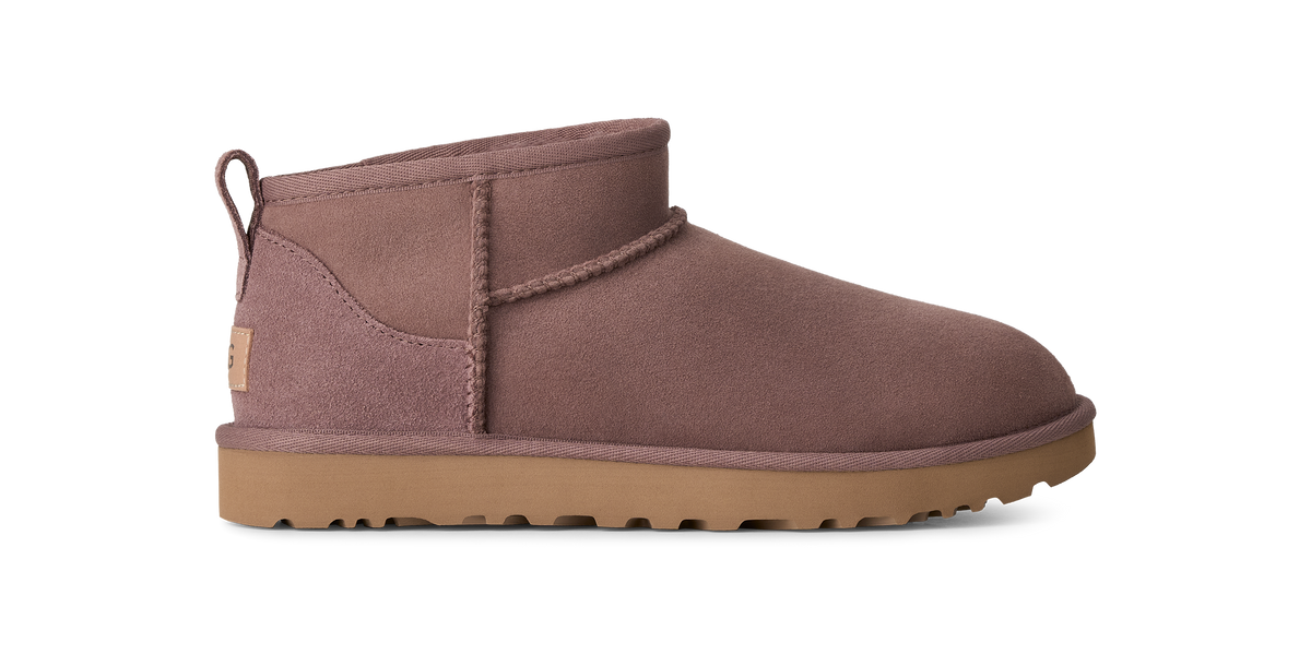 A single UGG Mini Classic bootie in a dusty mauve-brown suede, featuring a tan sole and a small tan UGG logo patch on the heel, shown against a plain white background.