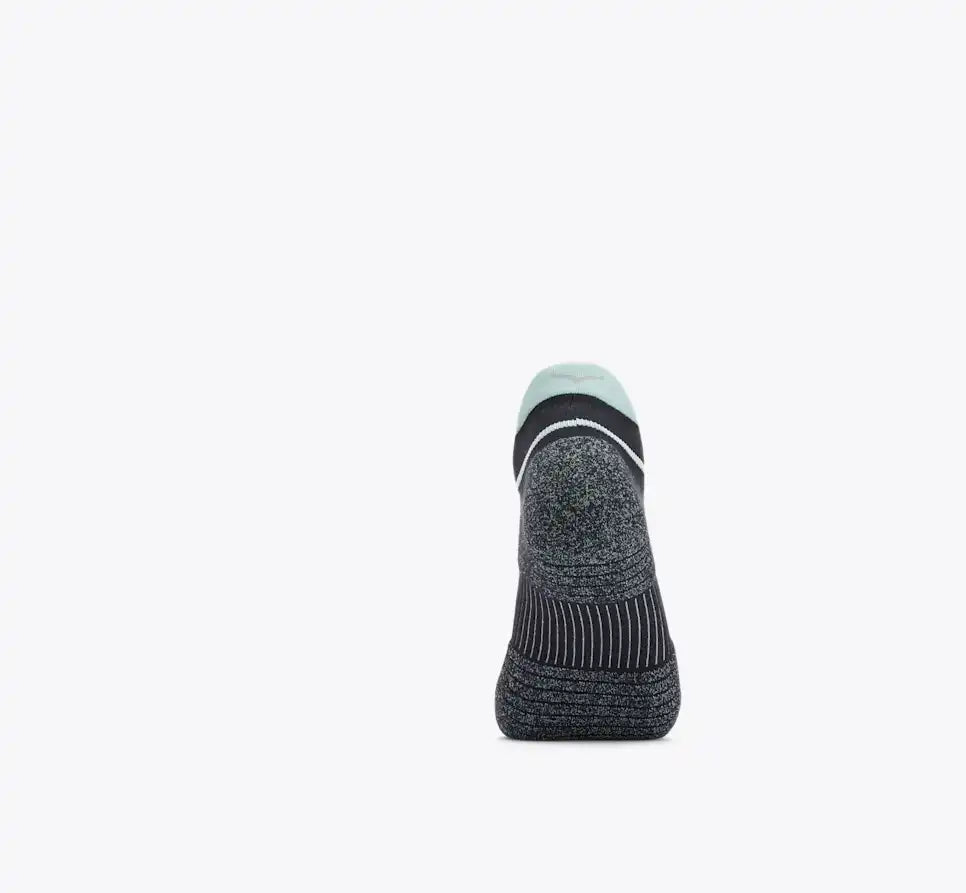Black sock with a white sole on a light gray background