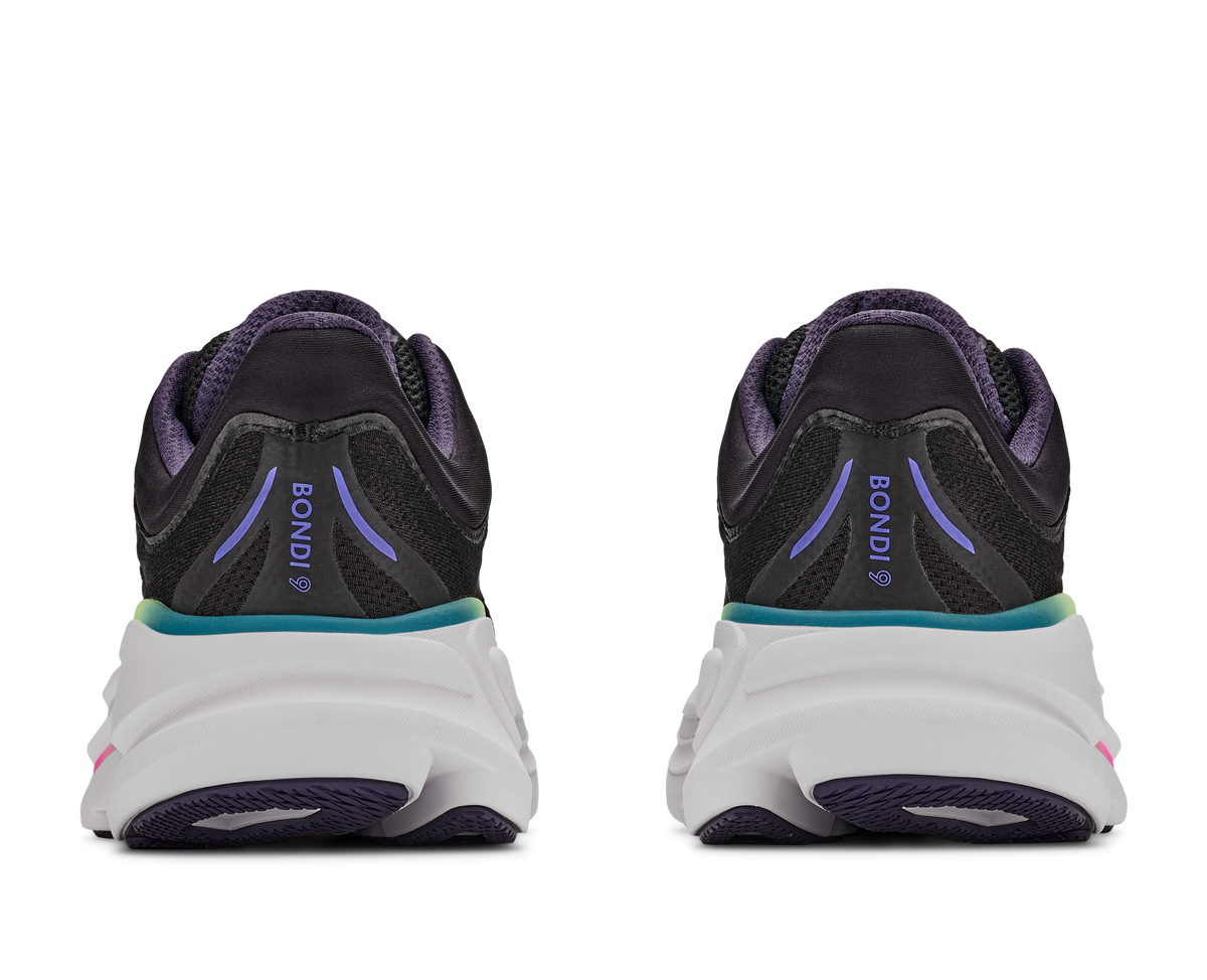 Black running shoes with purple accents on a white background