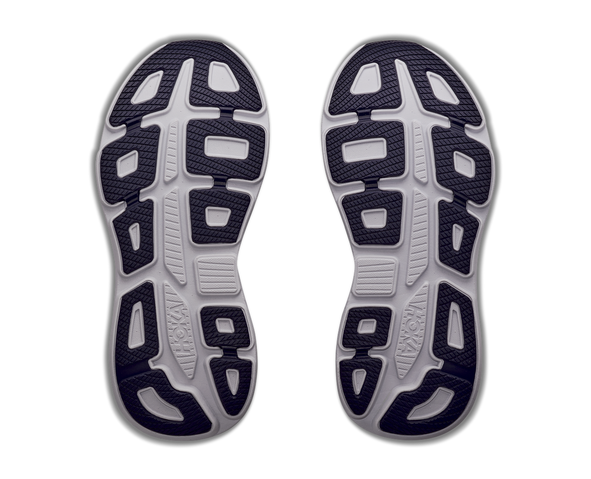 Top view of a pair of running shoes with tread pattern on a white background