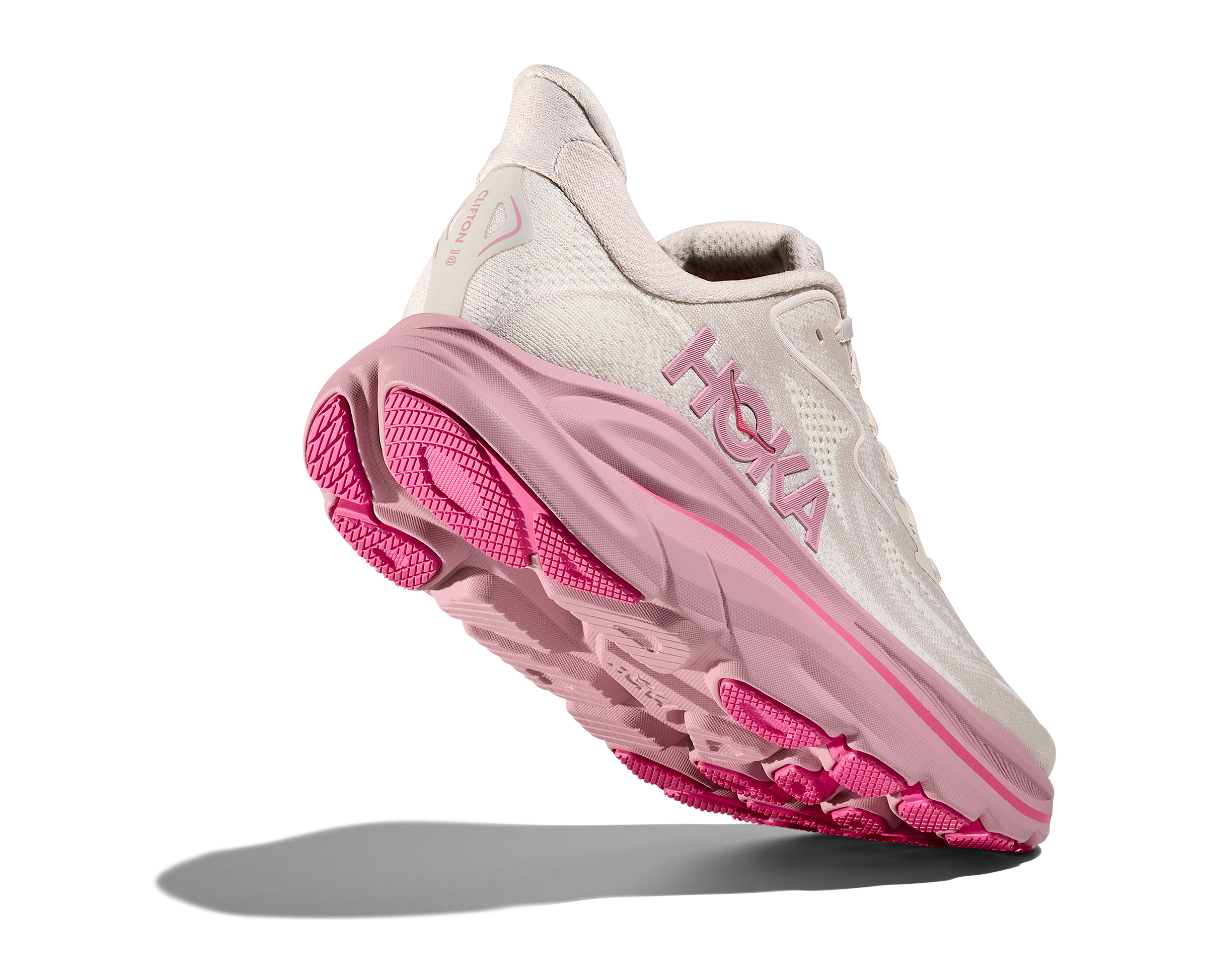 White and pink running shoe with 'Hoka' branding on a white background