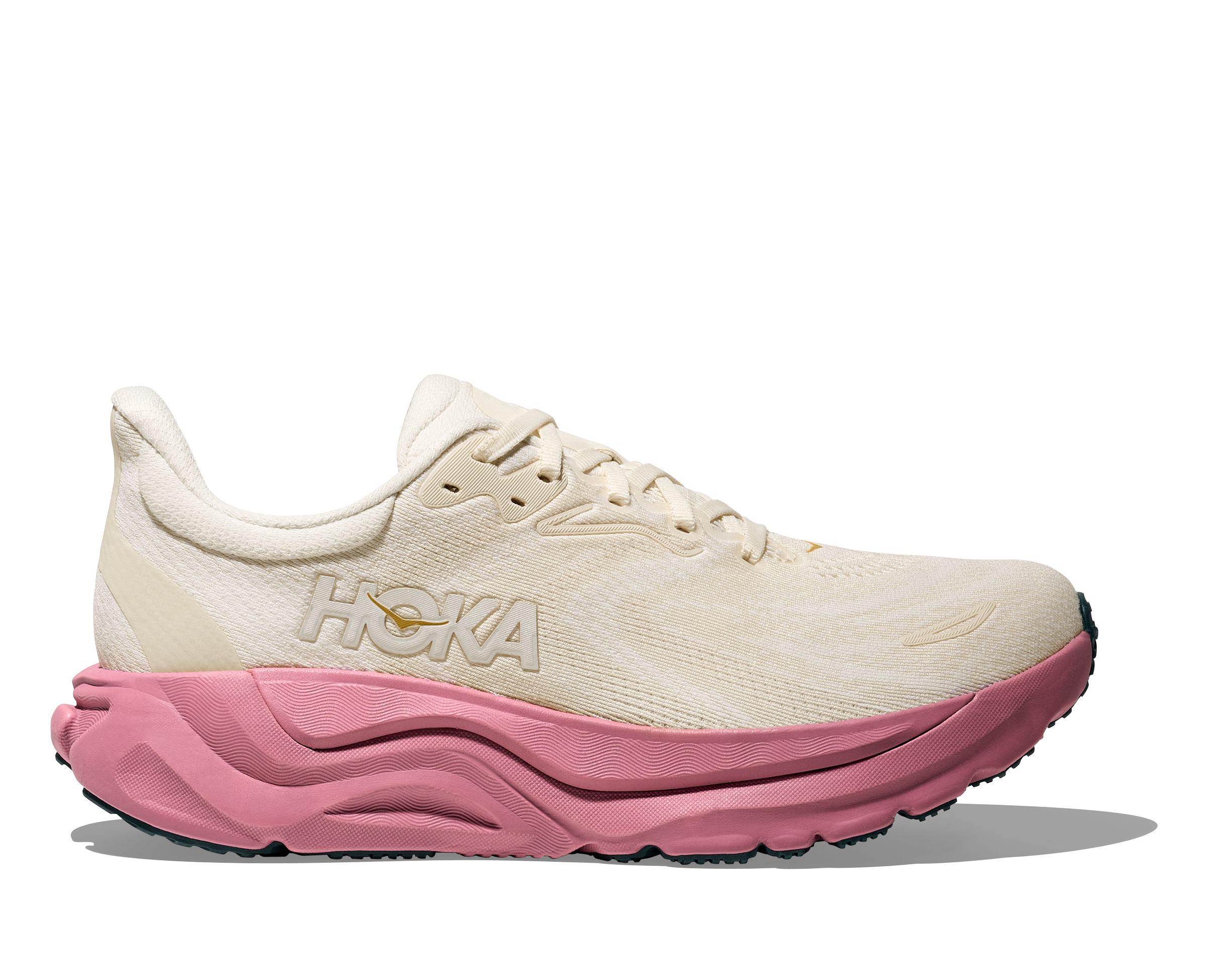 White running shoe with pink sole on a white background