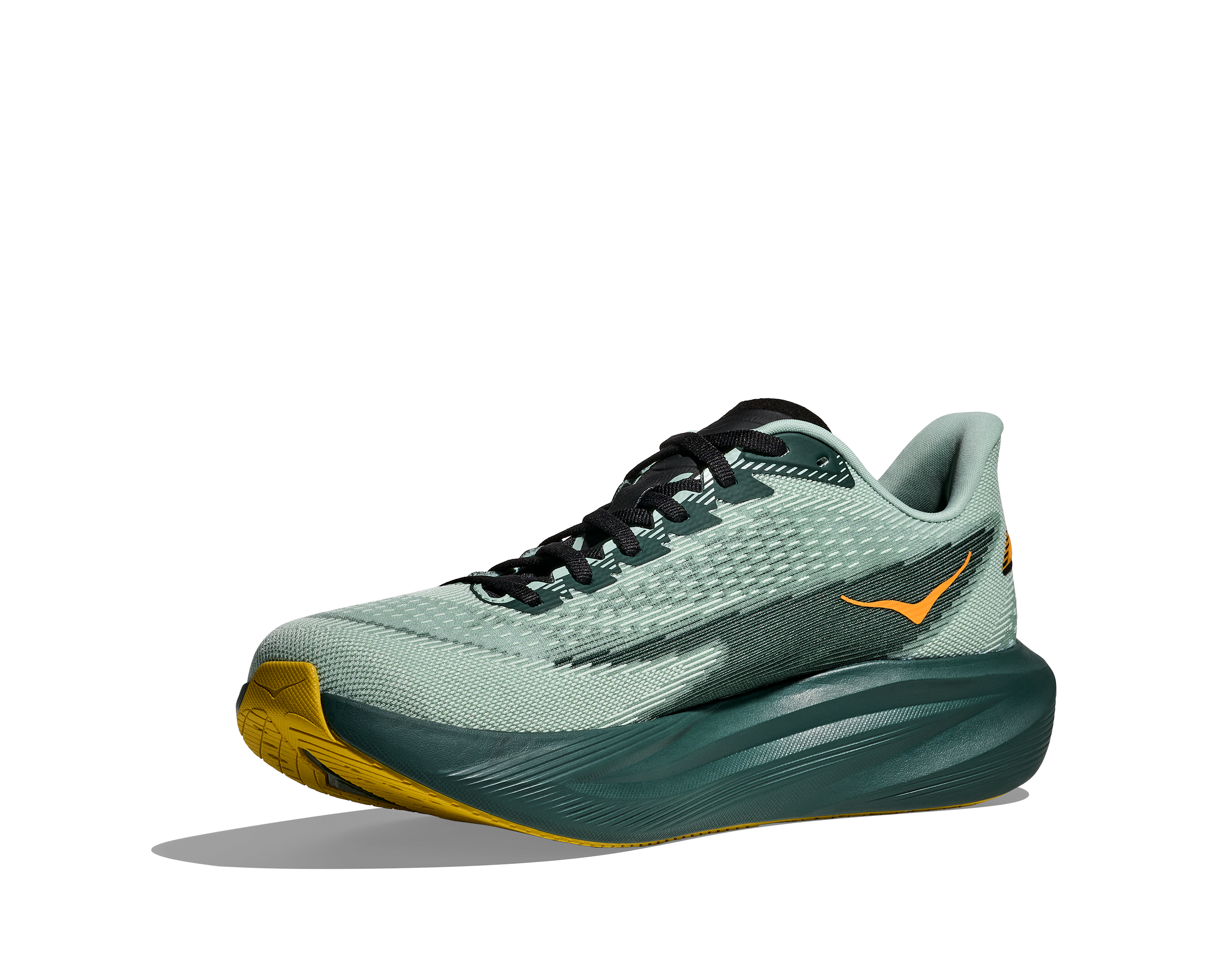 Green running shoe with yellow sole on a white background