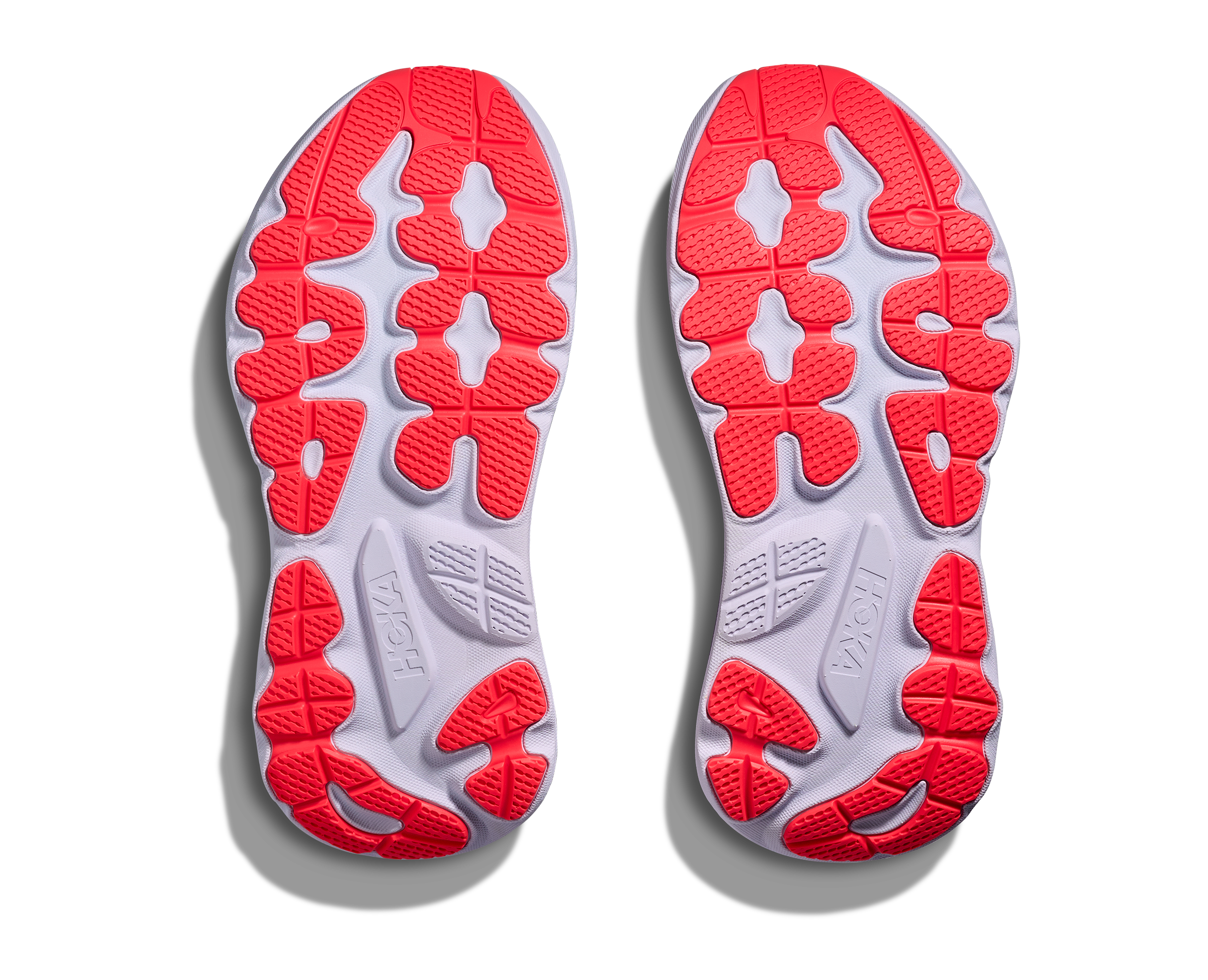 Close-up of red and gray shoe soles on a white background