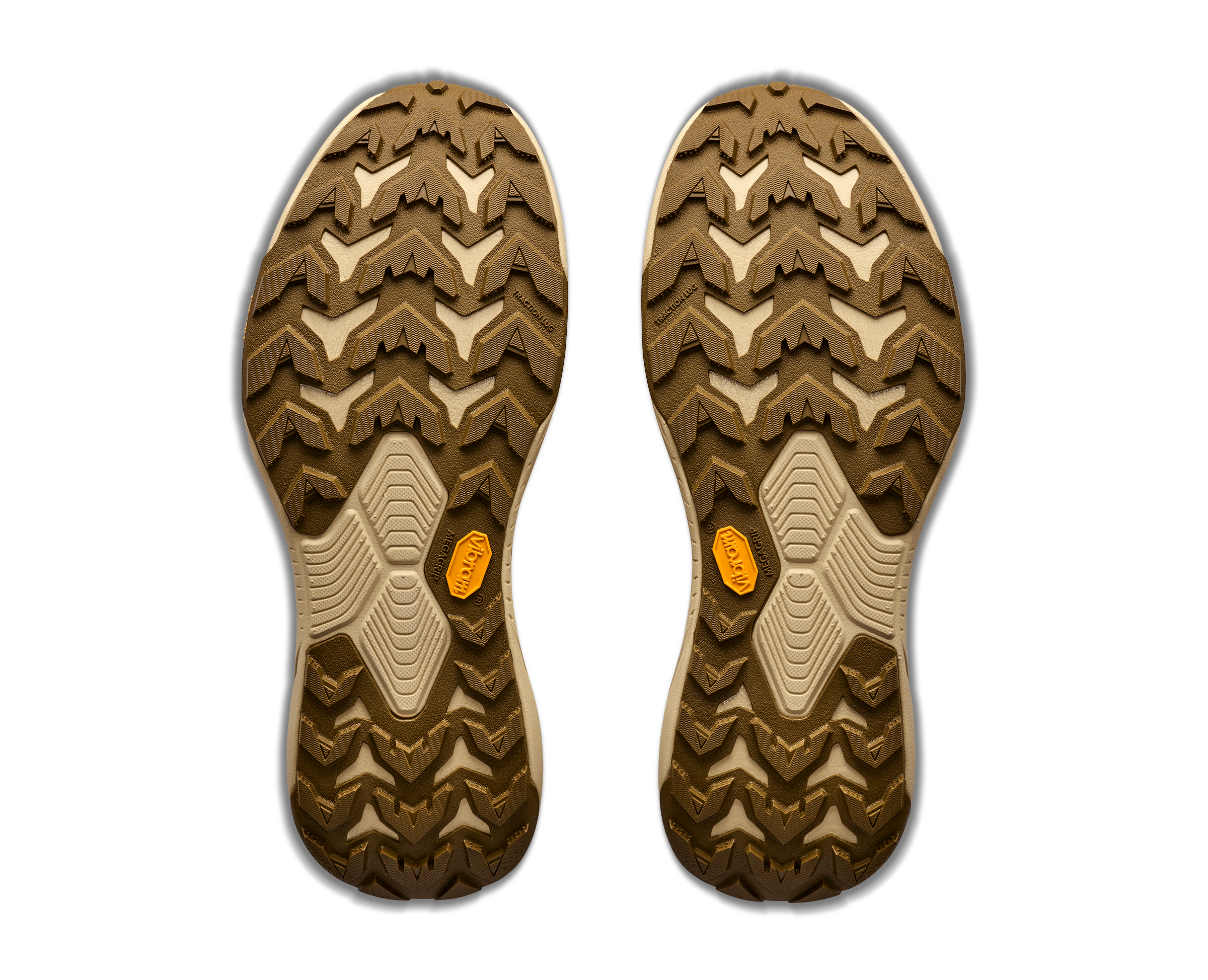 The treaded outsoles of a pair of shoes, shown from above on a white background. The soles are primarily brown and beige with small orange Vibram logos.