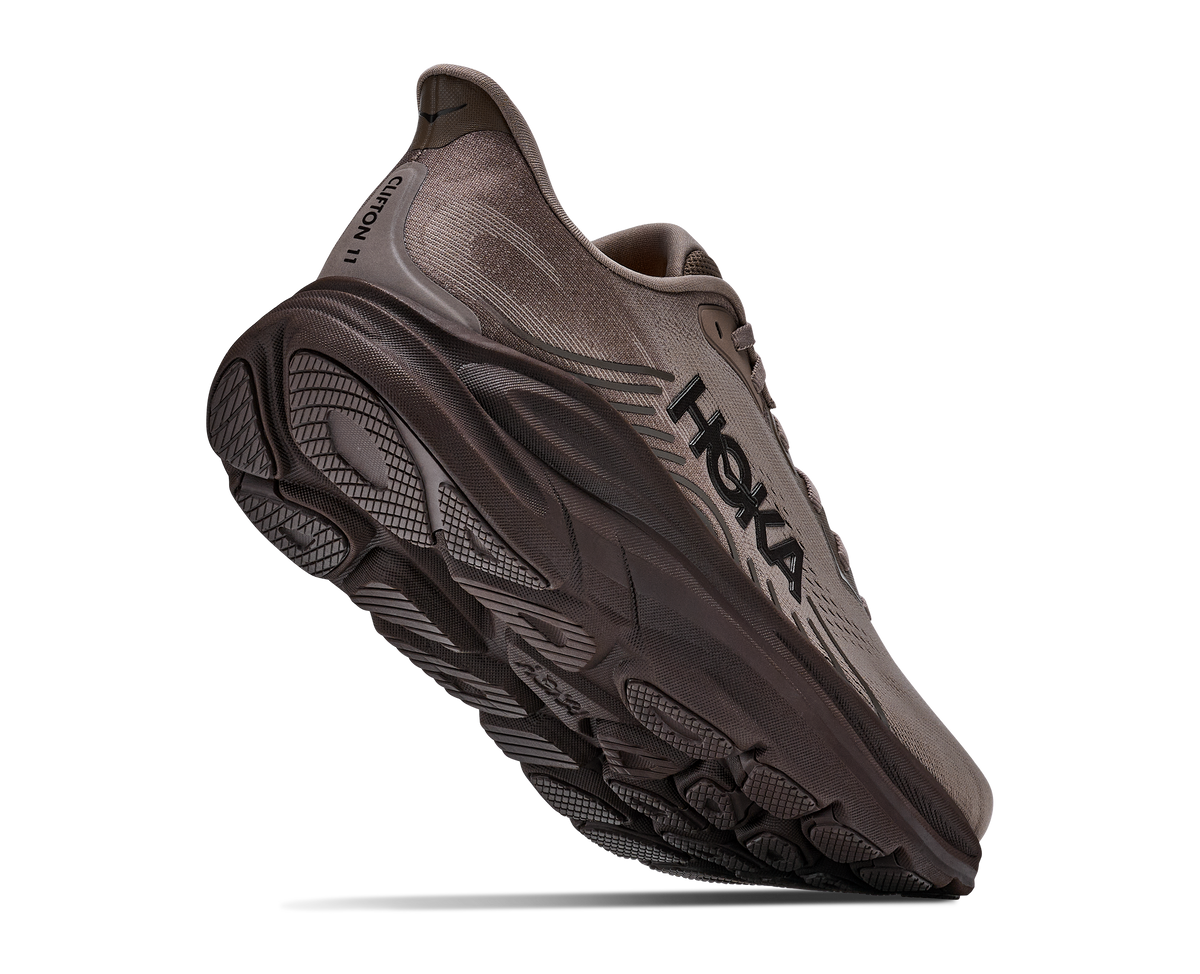 Brown running shoe with 'Hoka' branding on a white background