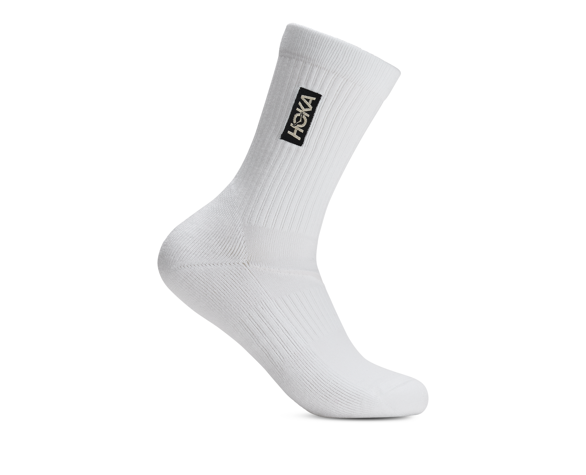 A single white crew sock with a black rectangular HOKA logo patch on the side, shown against a plain white background.