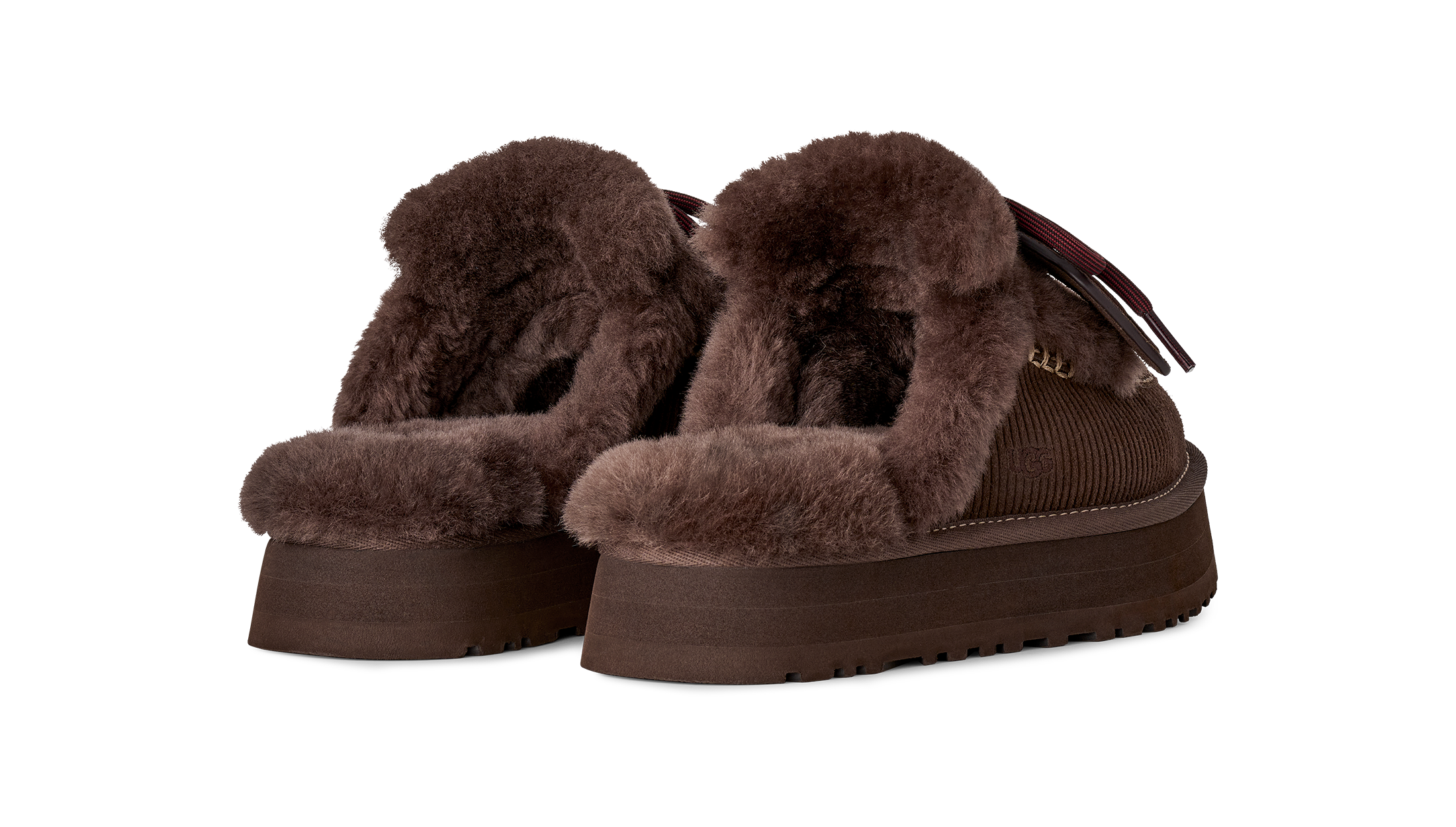 Brown platform shoes with fluffy texture on a white background
