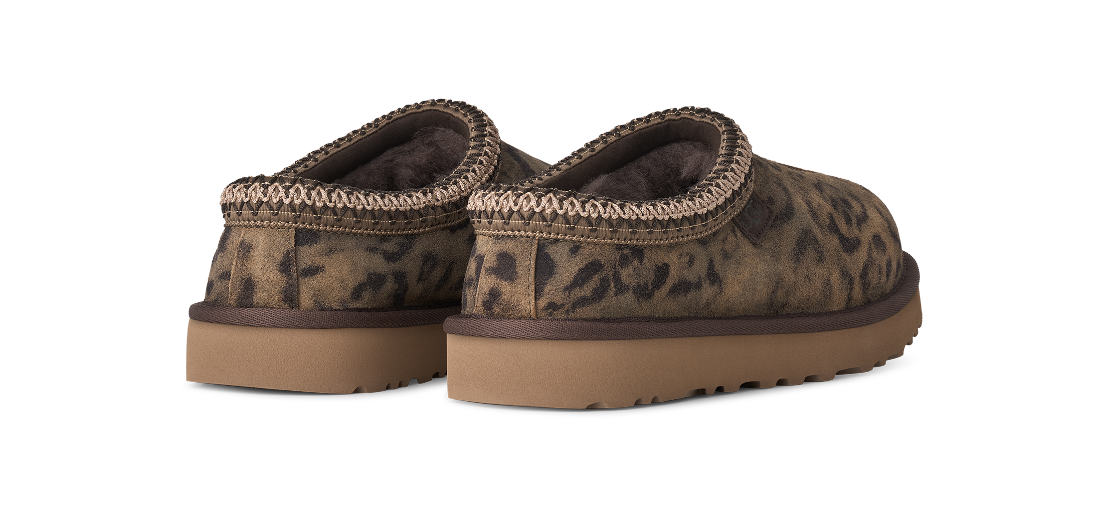 Pair of brown slip-on shoes with leopard print pattern on a white background