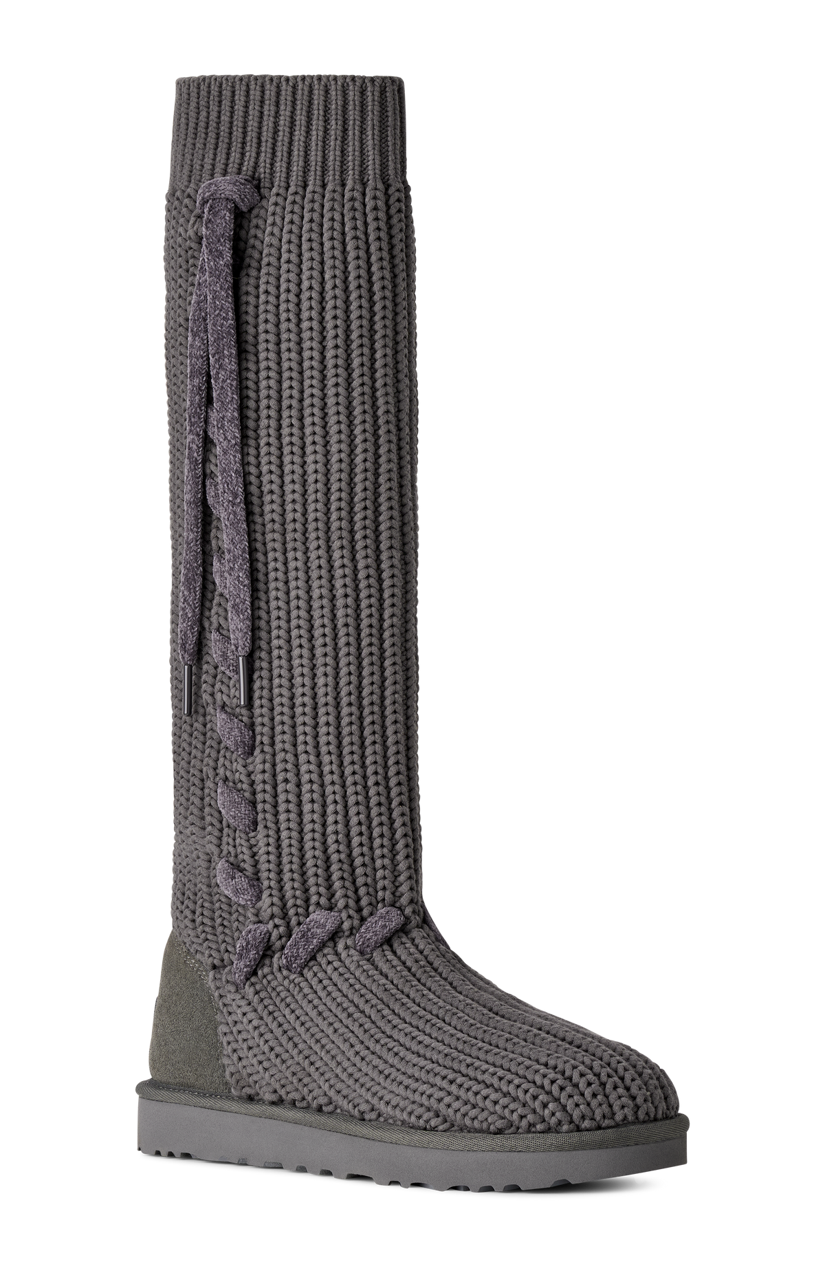 A single knee-high ribbed knit boot in dark gray with a matching braided pull detail and a thick dark gray sole, shown against a plain white background.
