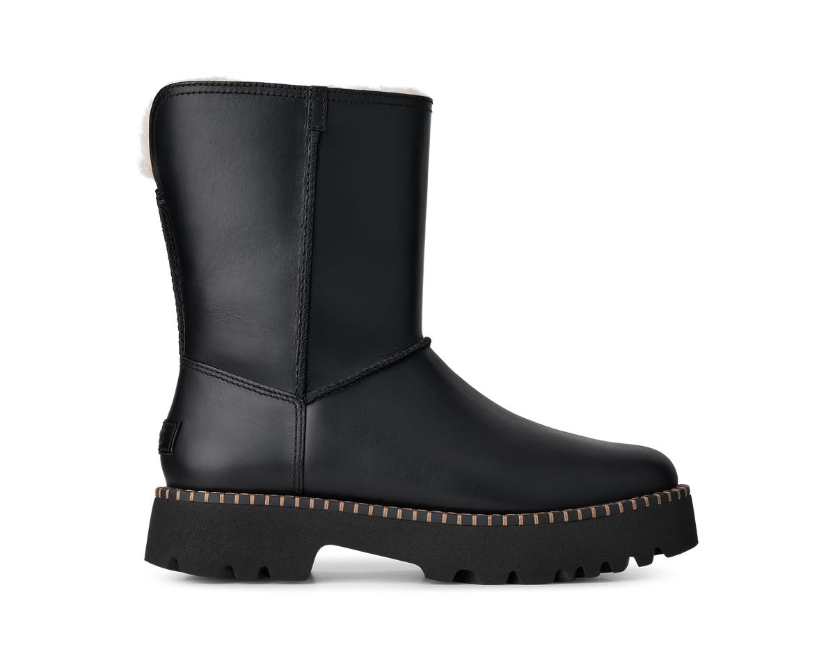 A single black leather ankle boot with a thick lug sole and a white shearling lining visible at the top, shown from a side profile on a white background.
