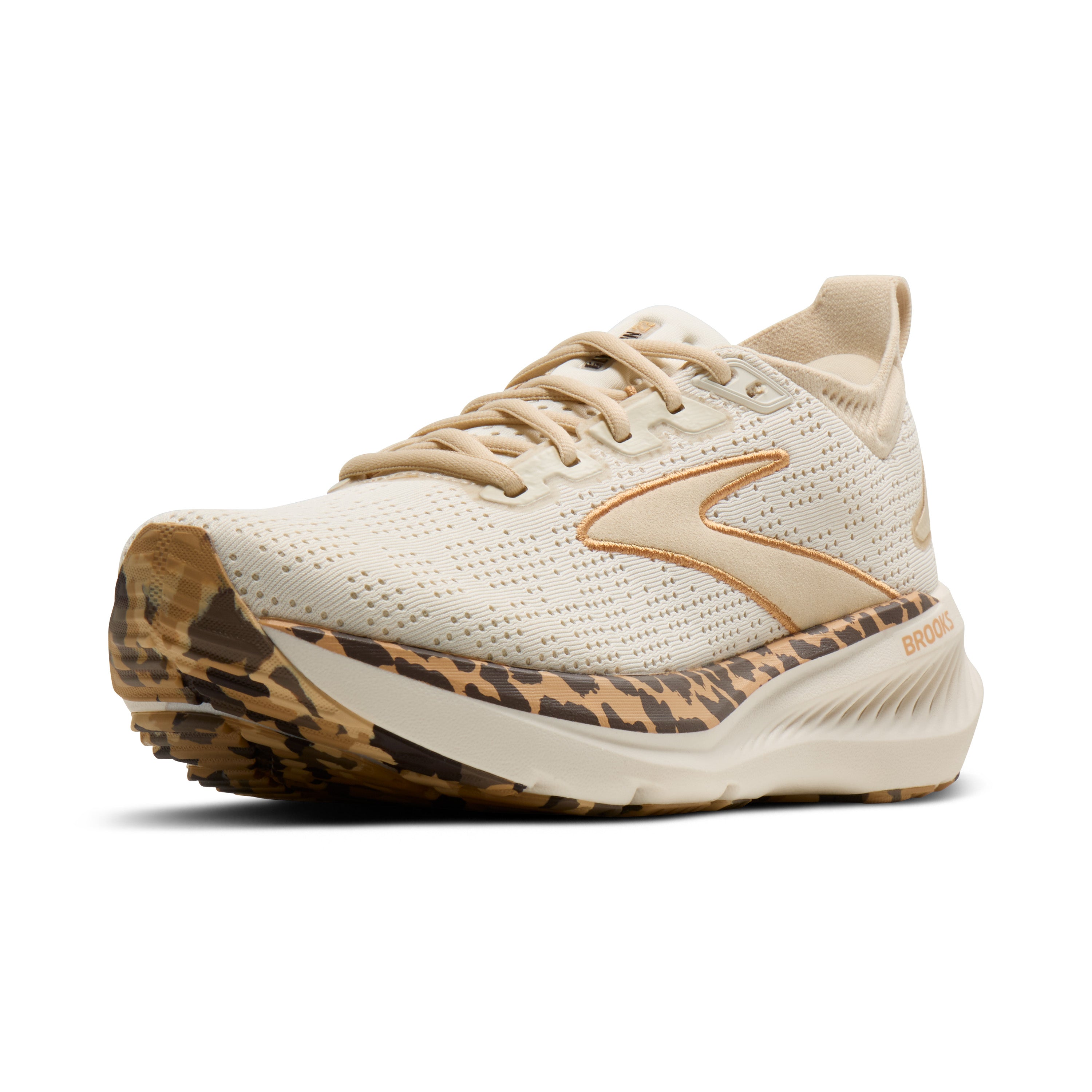 Beige running shoe with leopard print sole on a white background