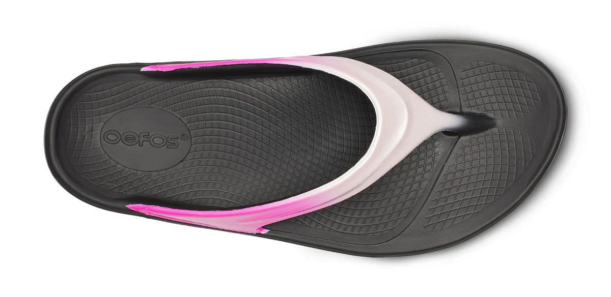 Black and pink sandal with 'Oofos' branding on a white background