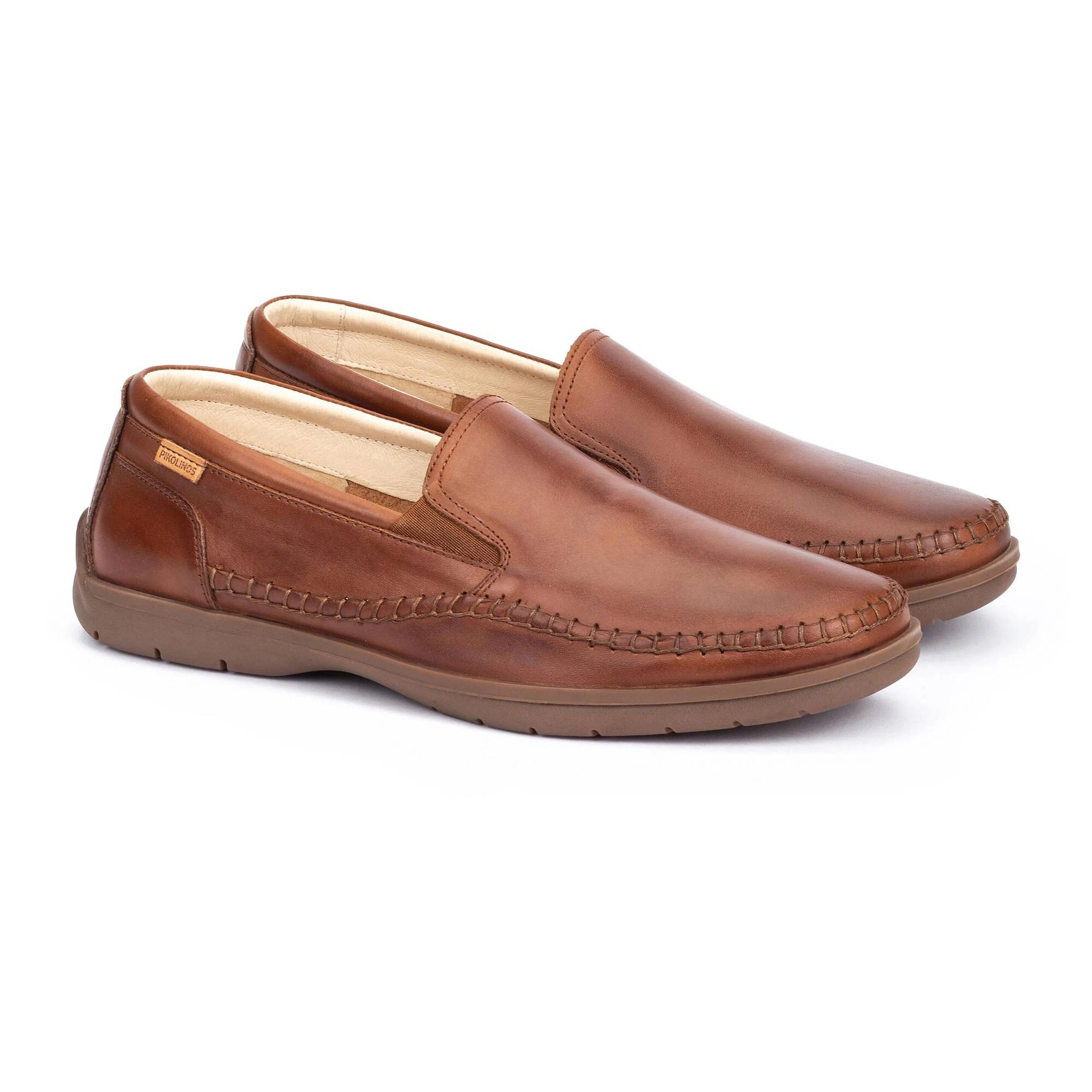 Pair of brown loafers on a white background