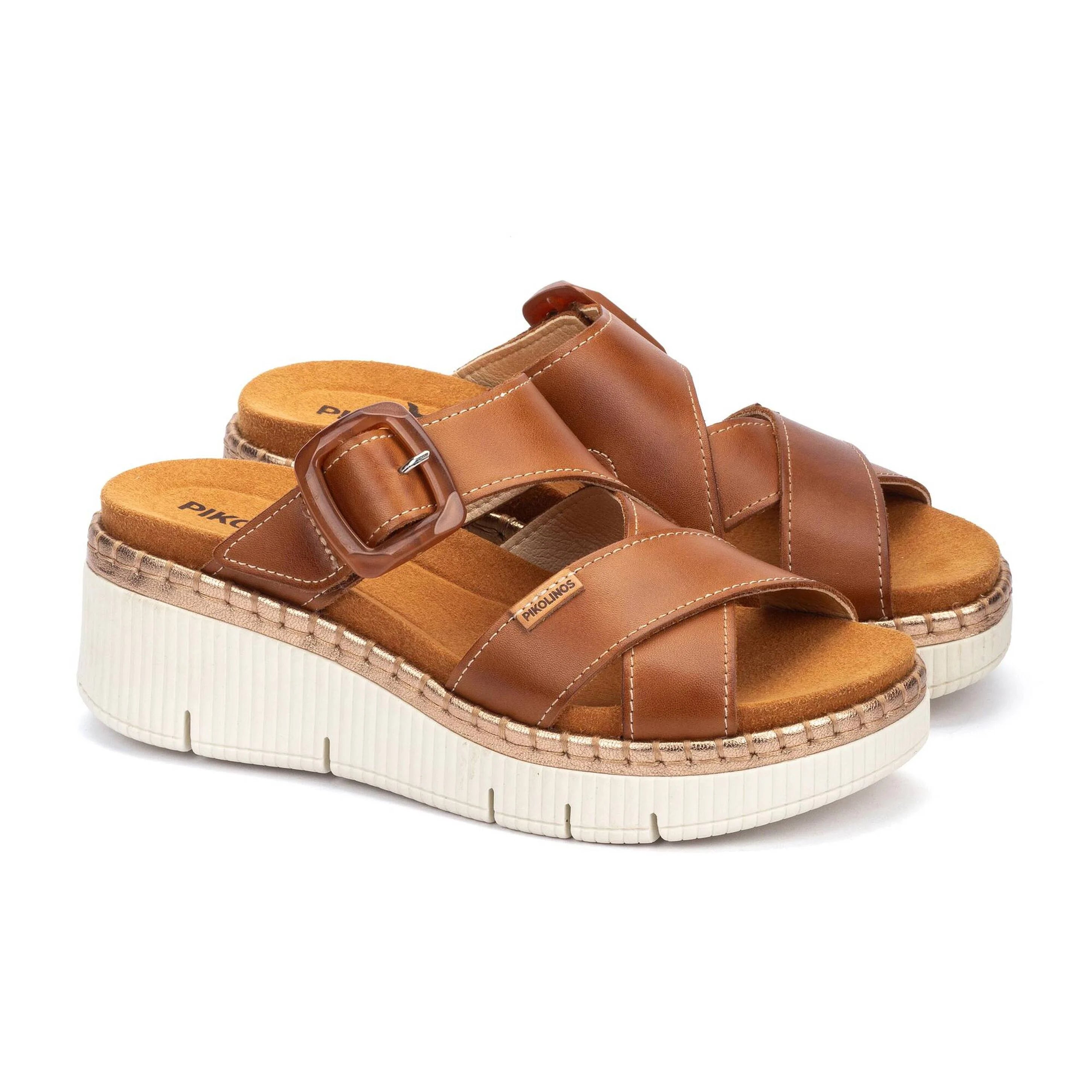 Brown sandals with a platform sole on a white background