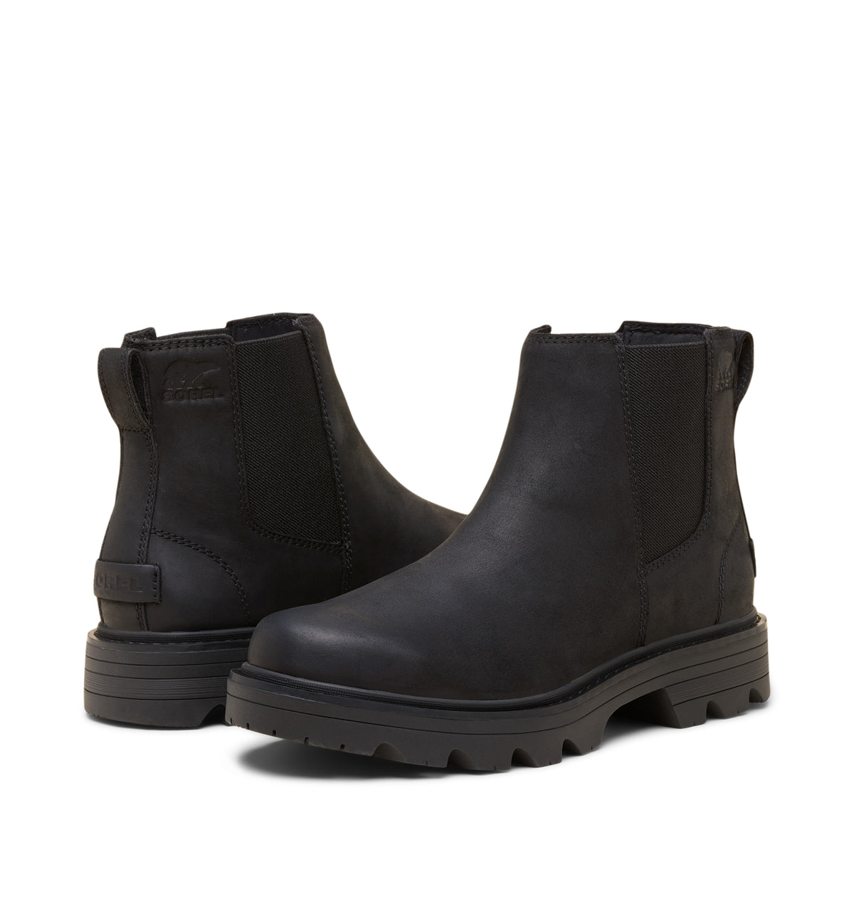 A pair of black Chelsea-style ankle boots with elastic side panels and chunky lug soles, shown on a plain white background.