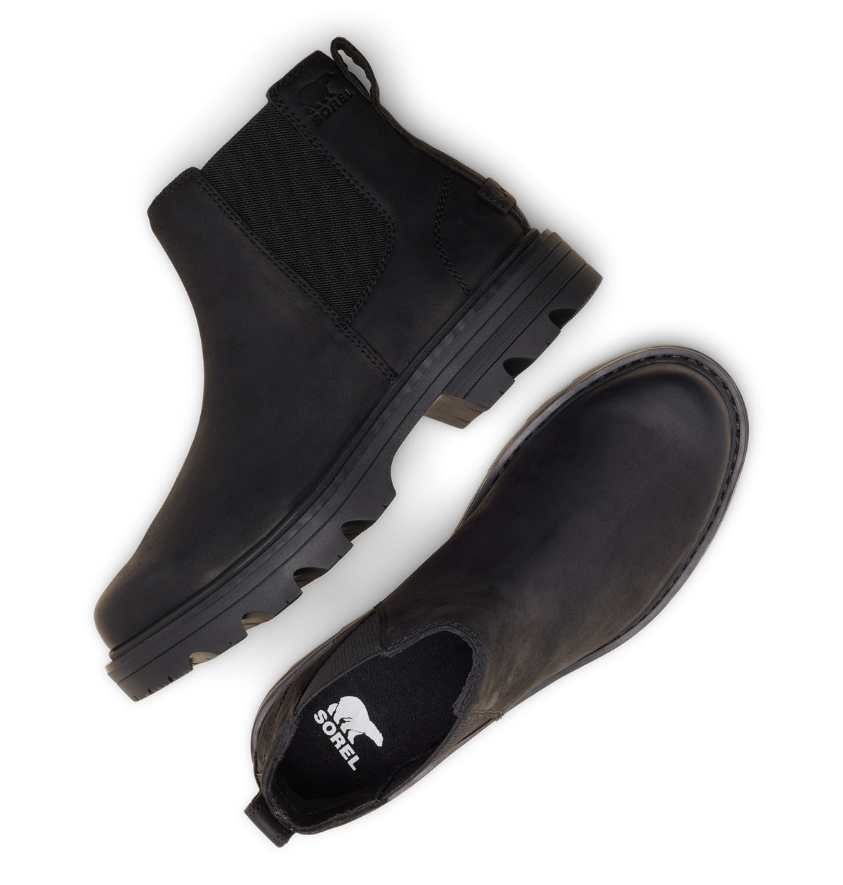 A pair of black Chelsea-style boots shown from top and side angles on a white background. One boot features a black elastic side panel, a black sole with a lug pattern, and a pull tab at the heel.